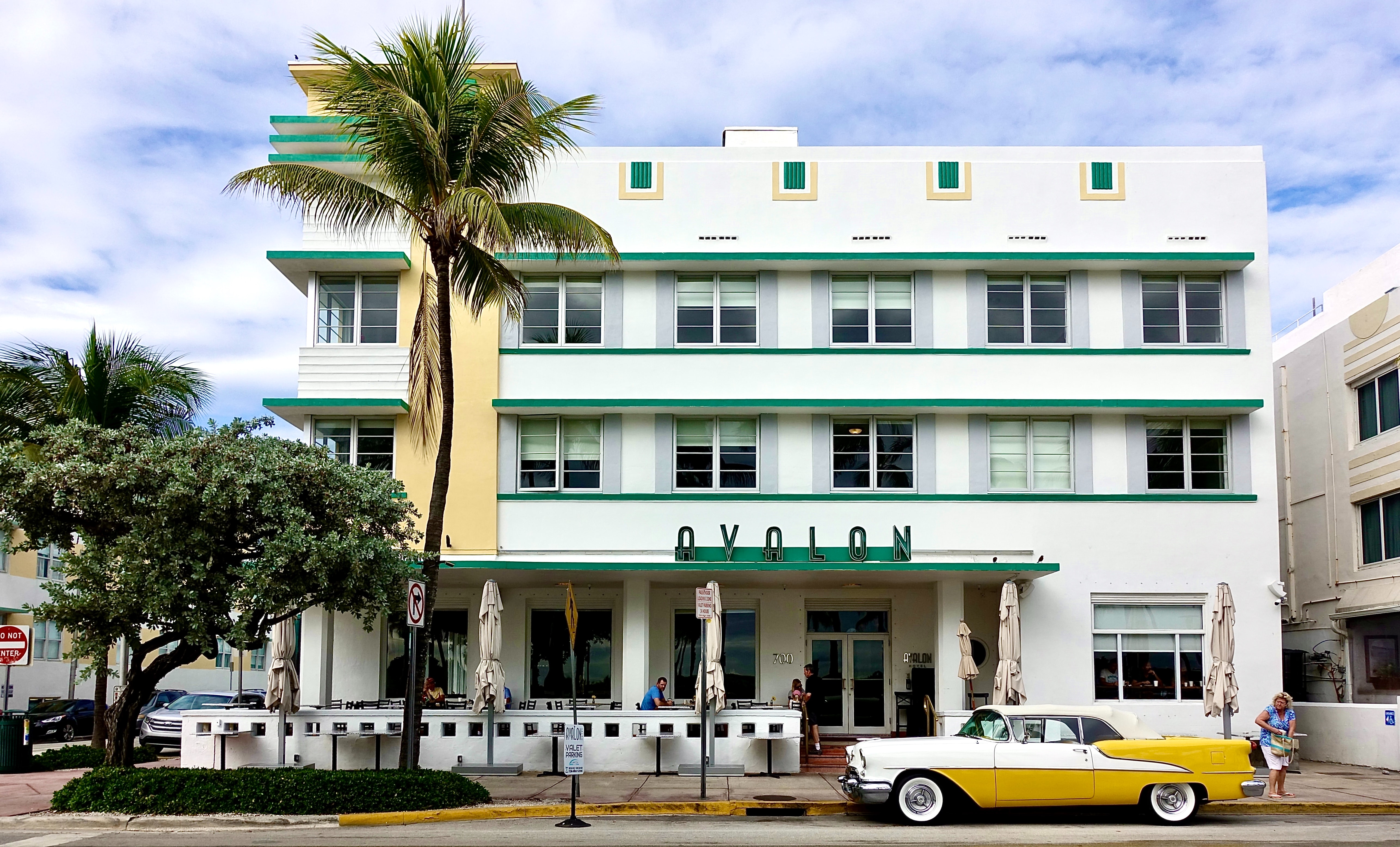 A vintage car parked in front of the Avalon hotel in Miami Beach