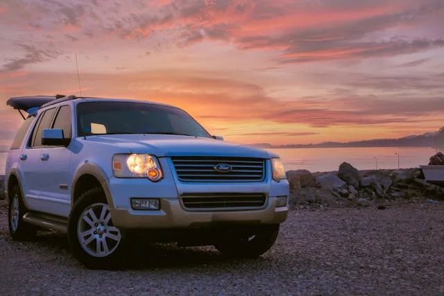 white ford explorer with a sunset