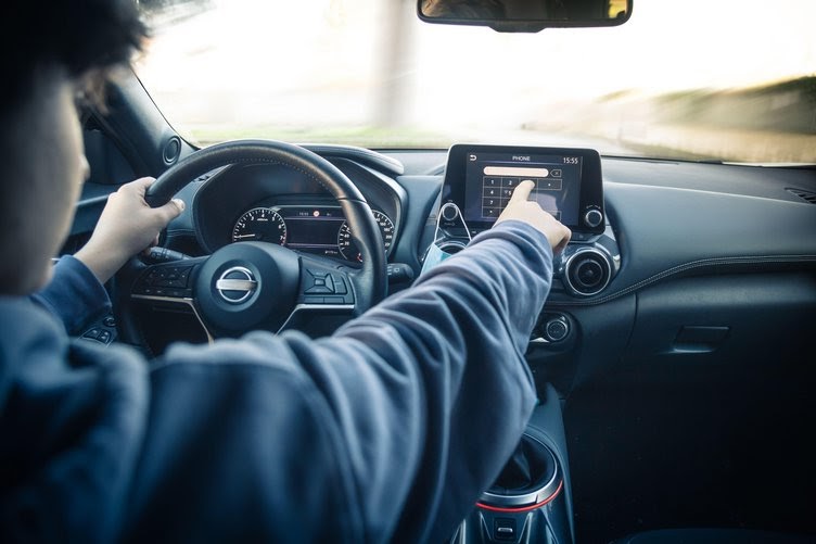 Photo of teenager driving a car while distracted