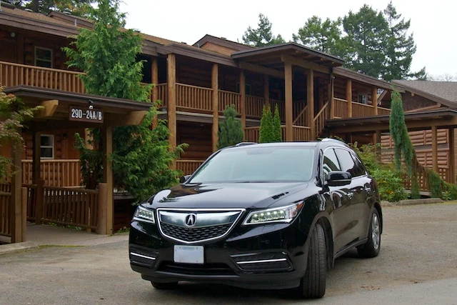 Acura MDX parked in front of a cabin