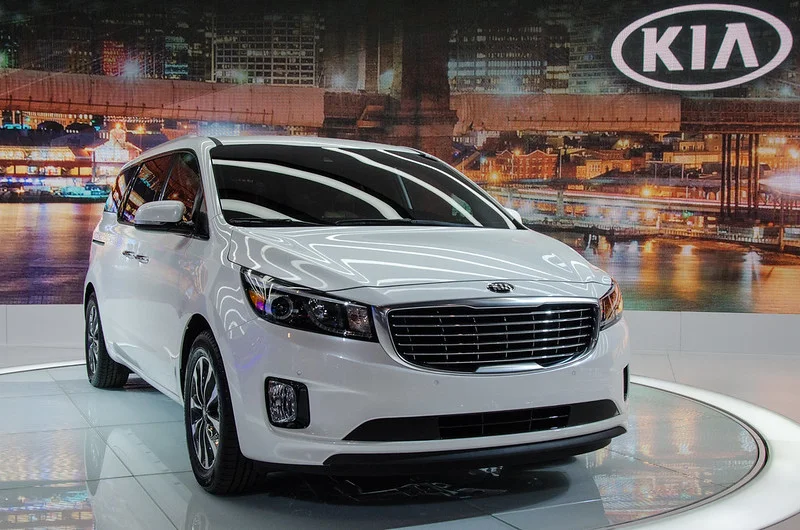 White Kia Sedona in a showroom