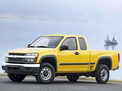 Yellow Chevy Colorado next to a lake