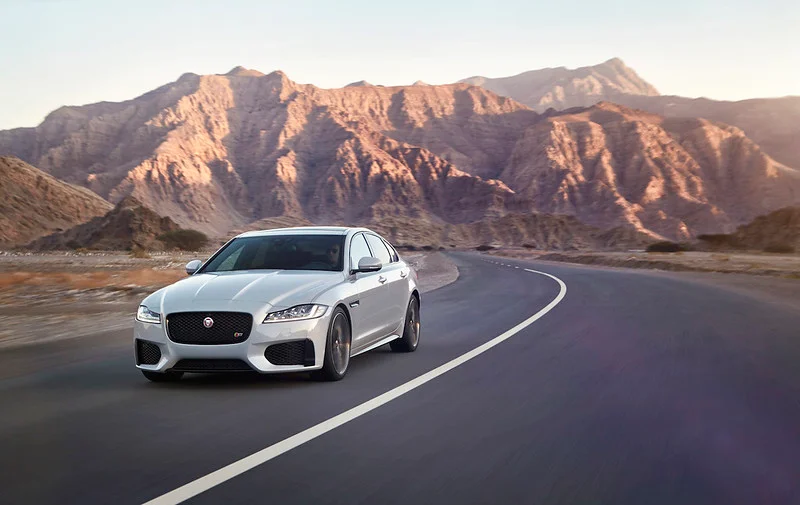 Jaguar XF driving through the desert