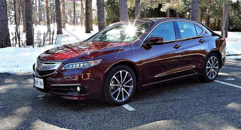 Red 2015 Acura parked in the woods