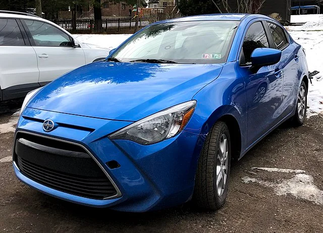 Blue Scion iA in a snowy parking lot