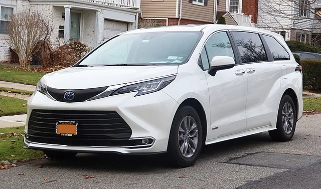 White Toyota Sienna in front of a house