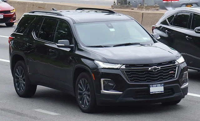 Black Chevy Traverse on a road