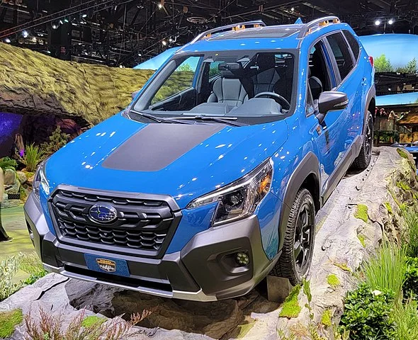 Blue 2022 Subaru Forester in a showroom