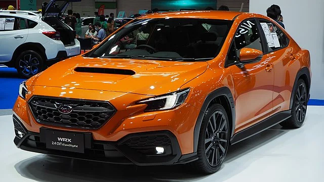Orange 2022 Subaru WRX in a showroom