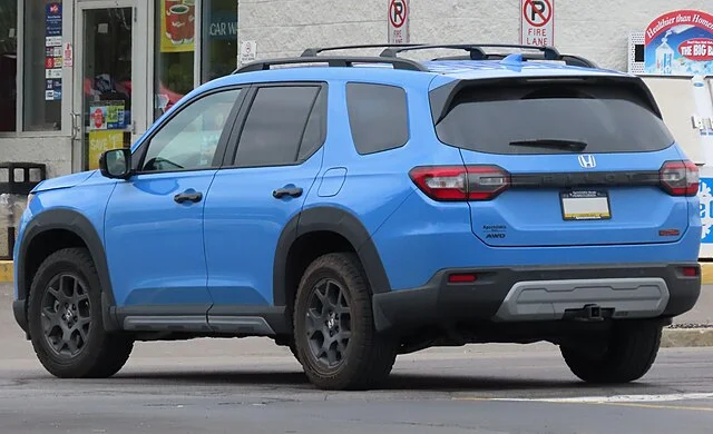 Rear view of a blue Honda Pilot on a street