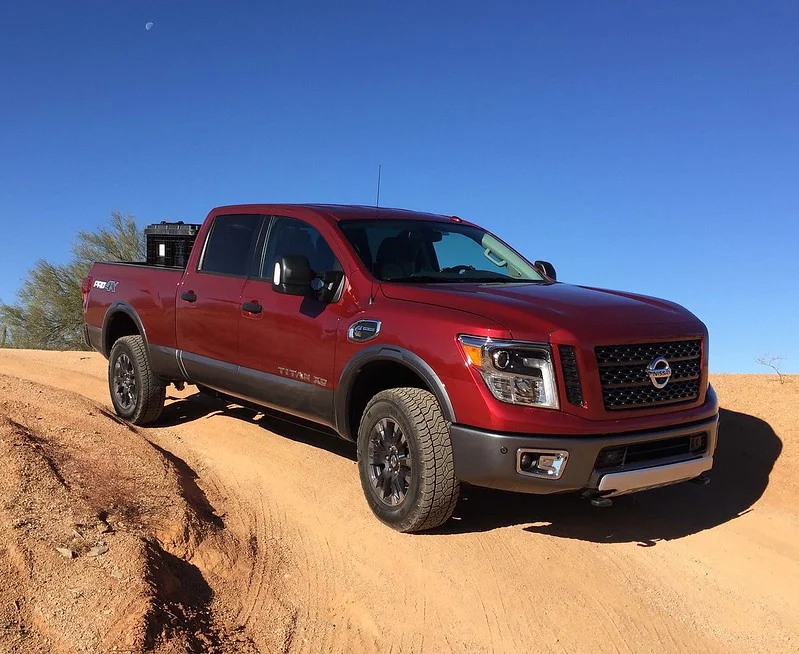 Red Nissan Titan XD parked in the desert