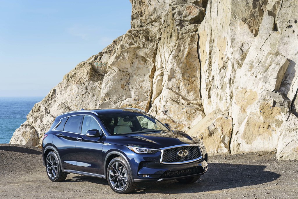 Blue Infiniti QX50 by the ocean