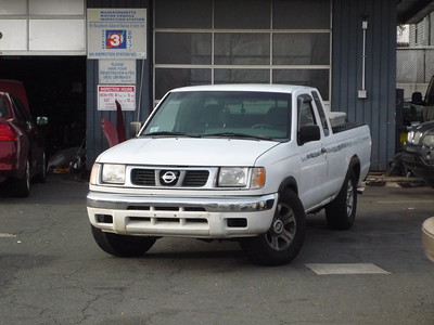 White Nissan Frontier at a car repair shop
