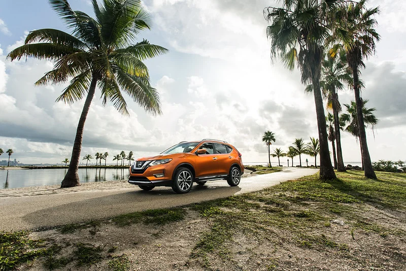 Orange 2017 Nissan Rogue on the shore