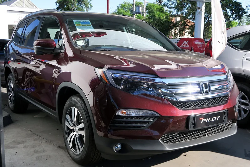 Red Honda Pilot parked in a lot