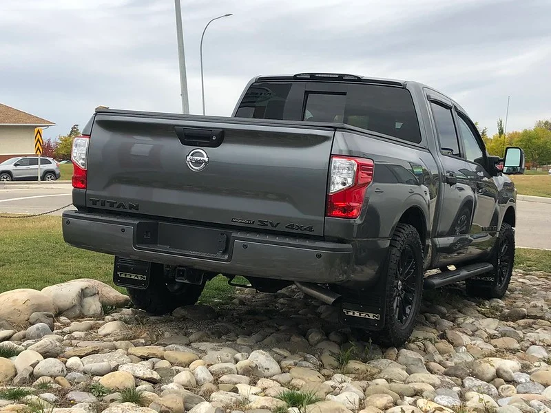 Grey Nissan Titan parked on rocks