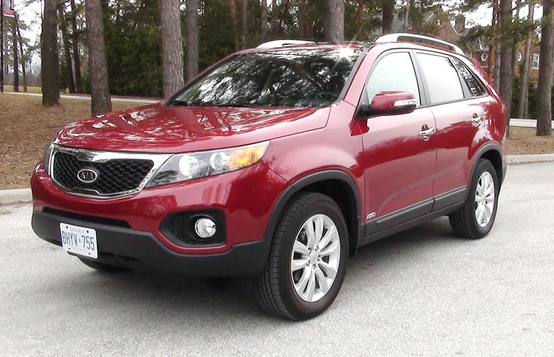 Red Kia Sorento parked in the forest