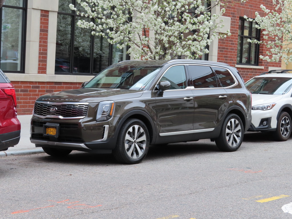 dark kia telluride parked on street