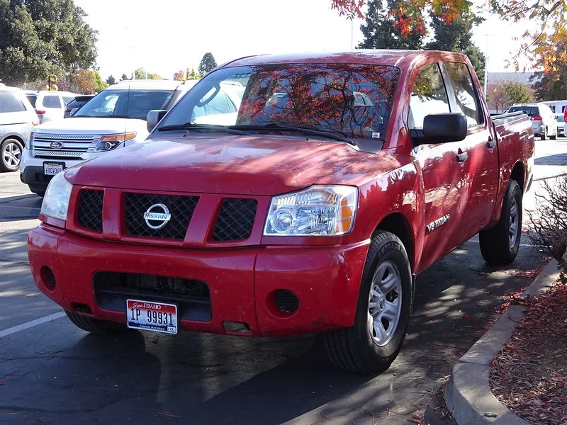 Red Nissan Titan in a parking lot