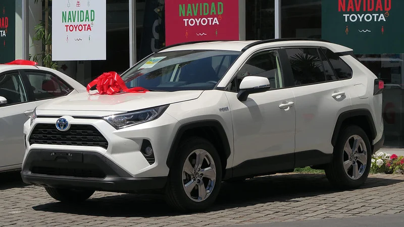 White Toyota RAV4 with a bow