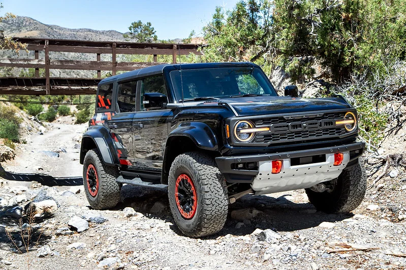 Black Ford Bronco in a dry creek bed