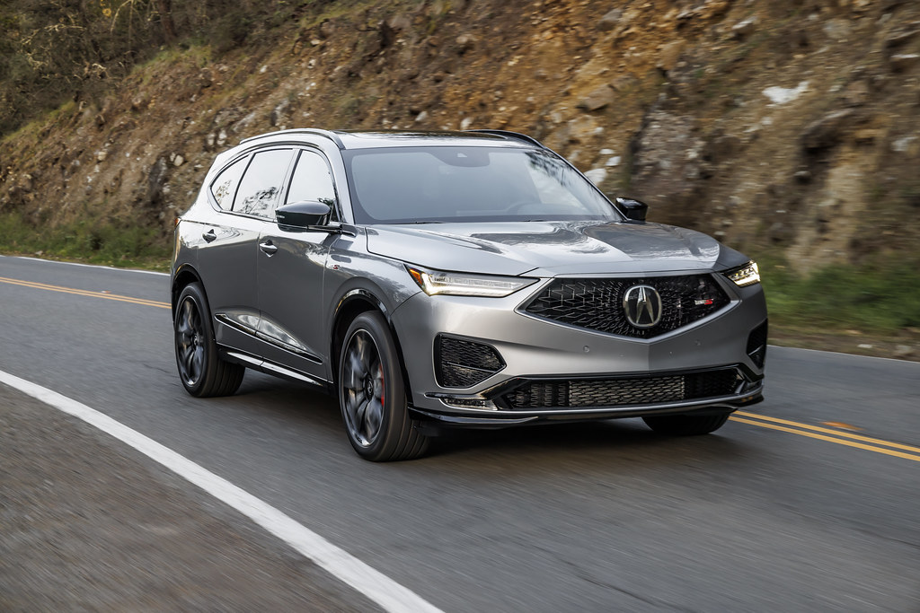 Acura MDX driving near a rocky cliff