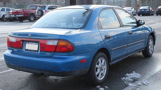 Blue Mazda Protégé in a parking lot