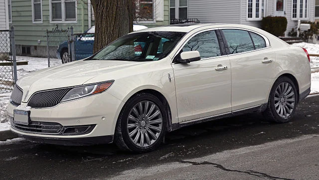 White Lincoln MKS on a snowy street