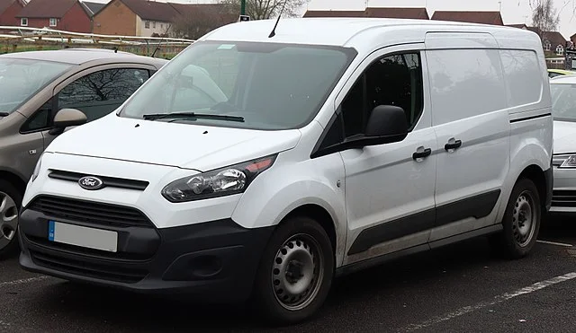 White Ford Transit Van in a parking lot