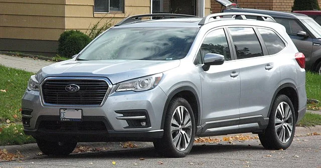 Silver Subaru Ascent parked outside of a house