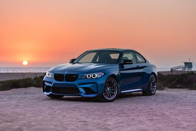 BMW X4 on the beach at sunset