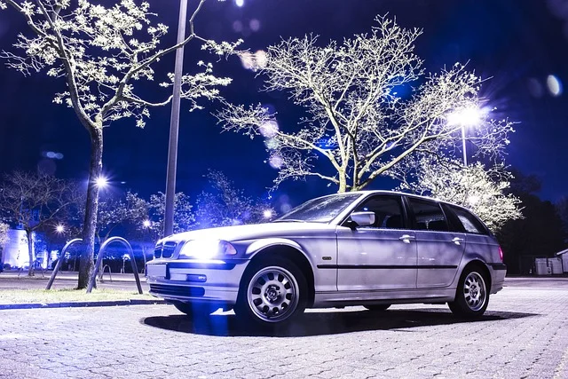 BMW 3-Series at night with its lights on