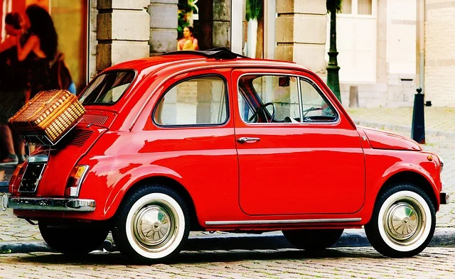 Red FIAT 500 on a cobblestone street