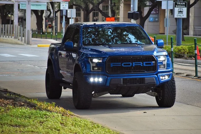 Blue Ford Raptor driving on a street