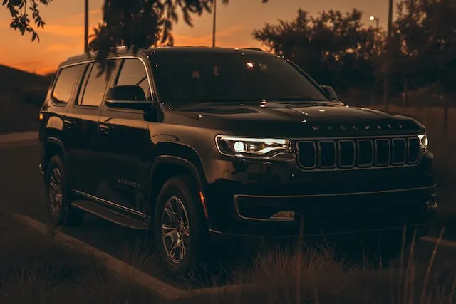 black jeep wagoneer at sunset