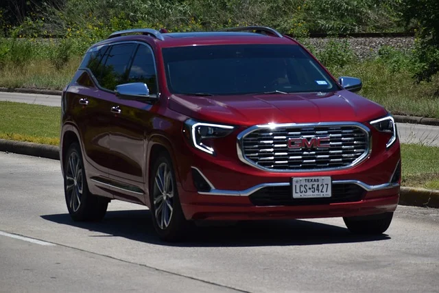 Red GMC Terrain on a road