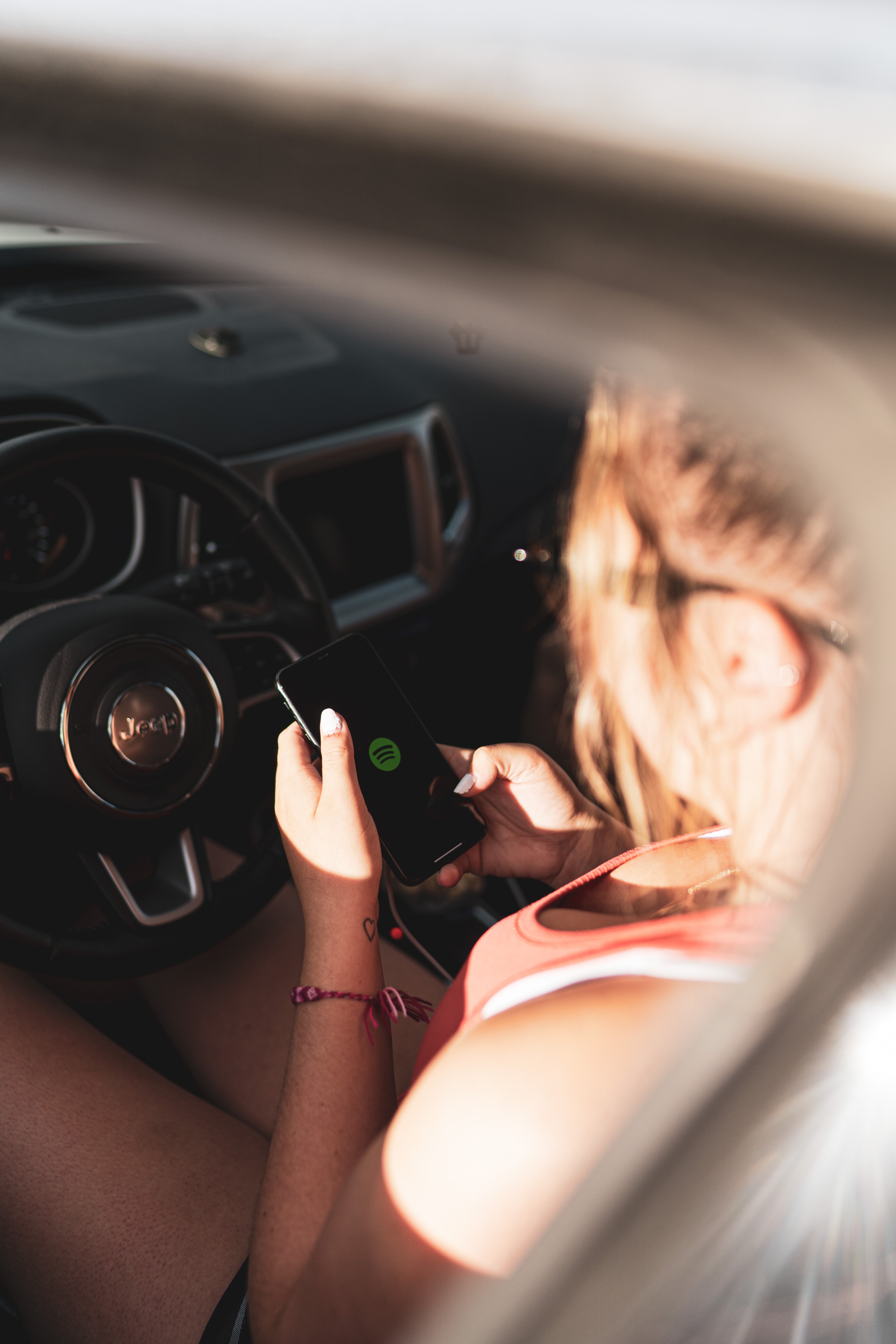 girl texting behind the wheel of a car