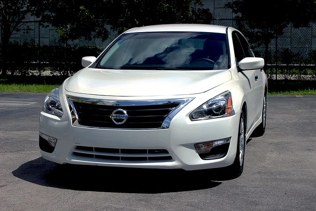 White Nissan Altima in a parking lot
