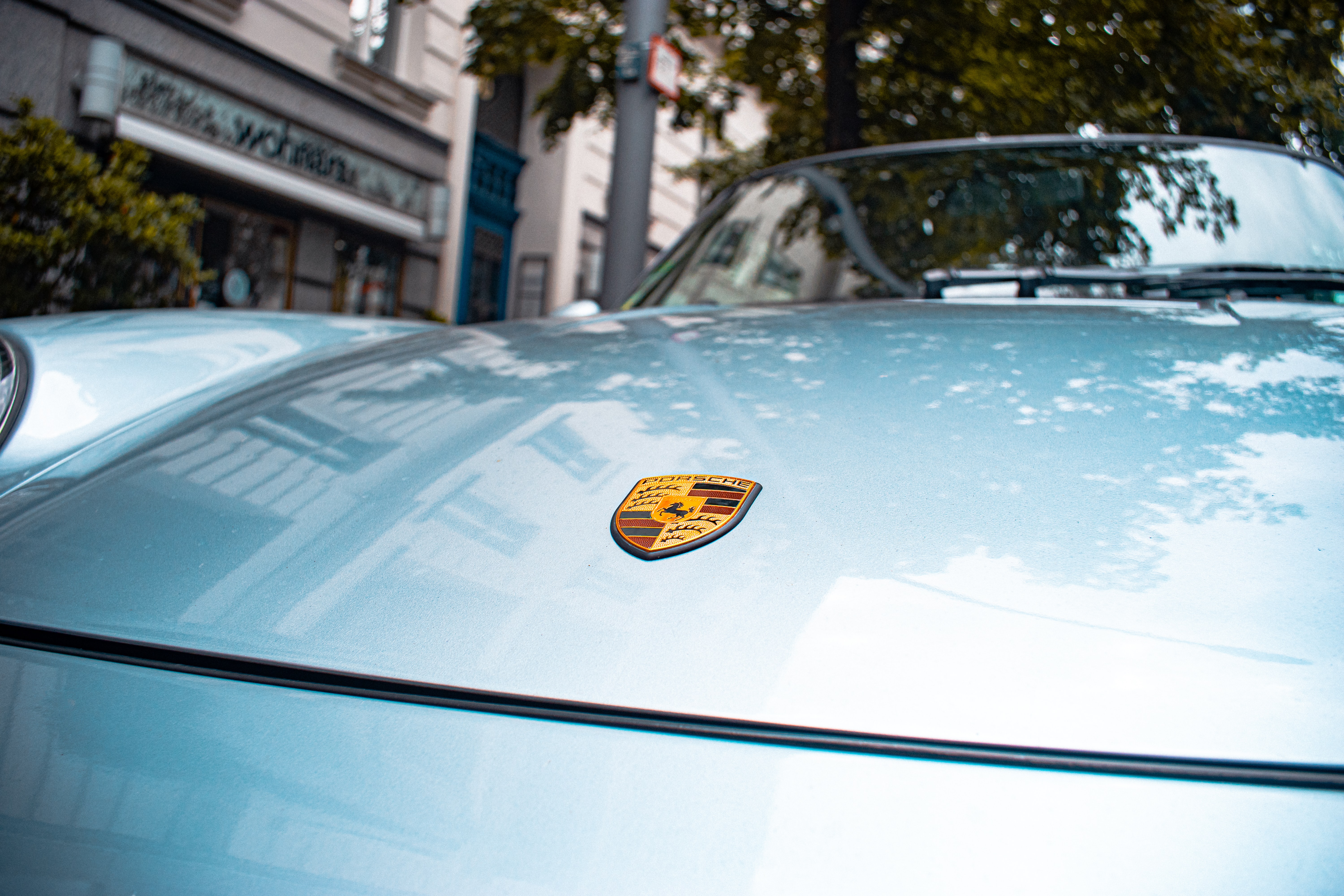 hood of a light blue porsche