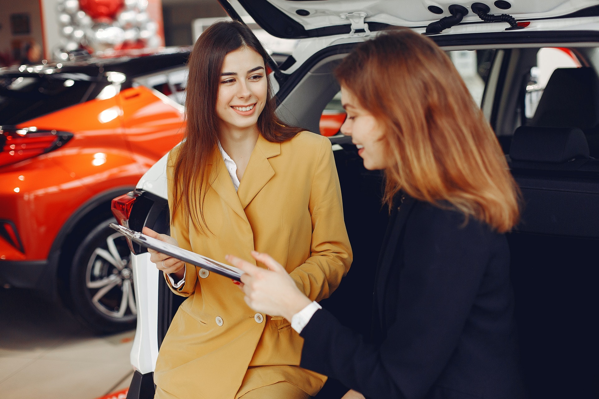 Photo of two women at a car dealership