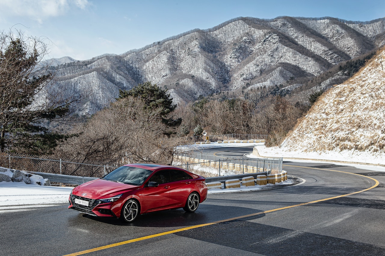 red hyundai elantra driving in the mountains