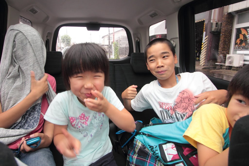 Photo of kids in the back of a family car