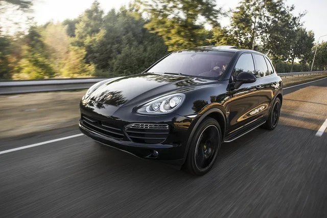 Porsche Cayenne driving on a road