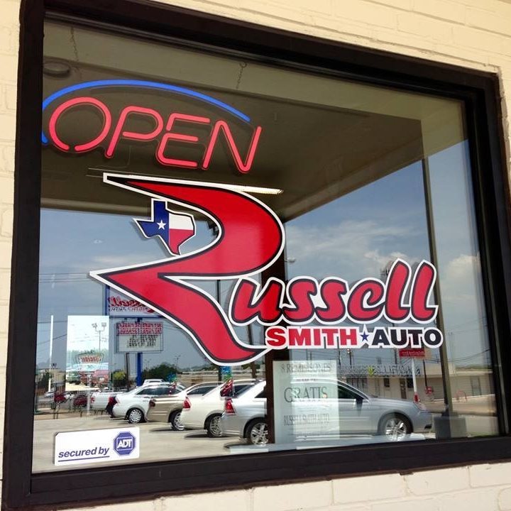 Photo of Russell Smith sign painted on dealership window