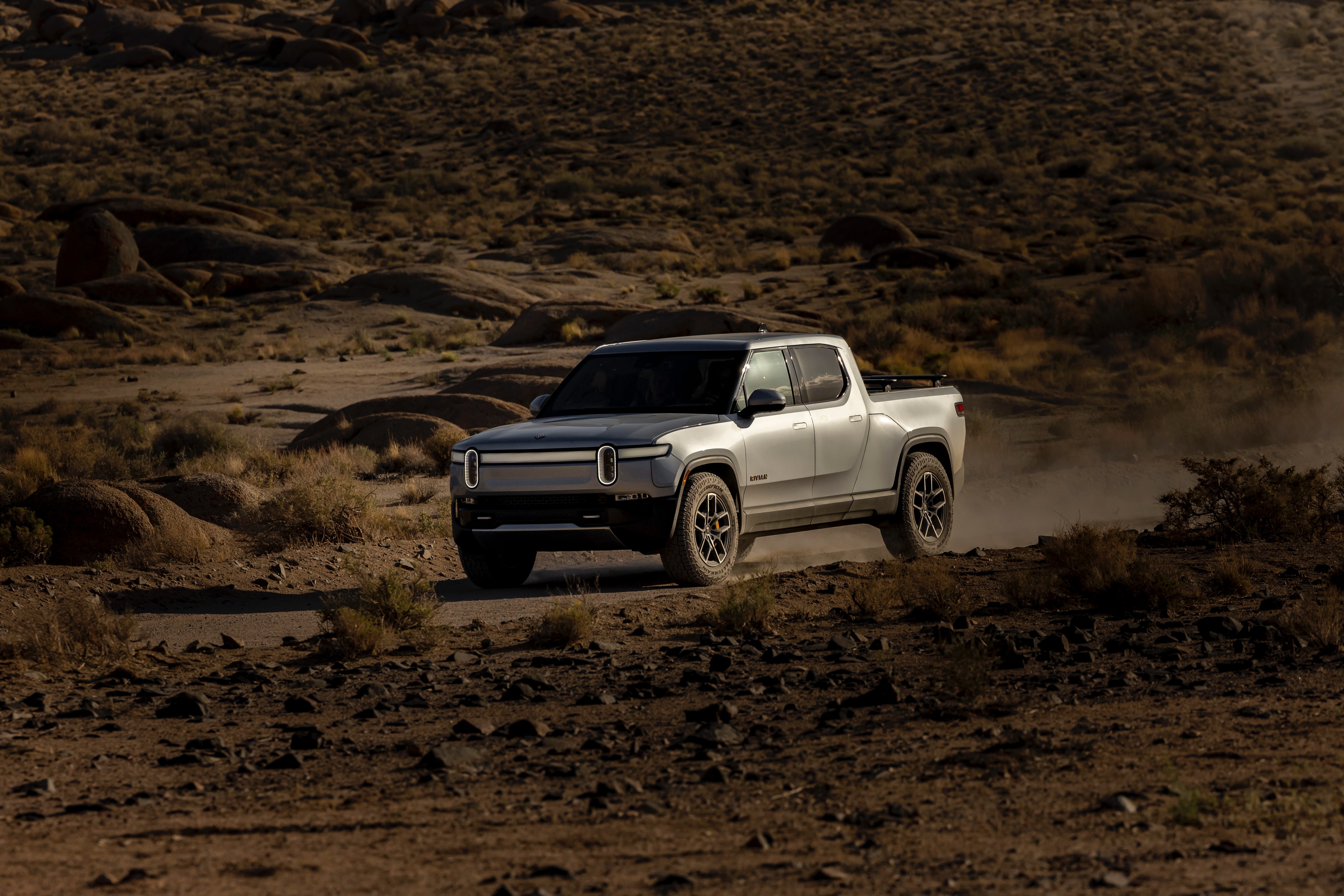 rivian truck driving in the desert
