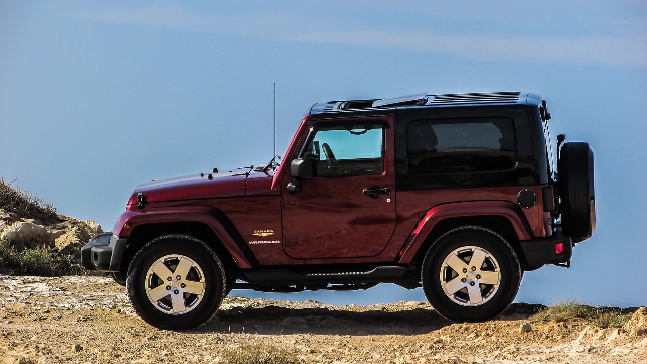 Red Jeep parked on a cliff