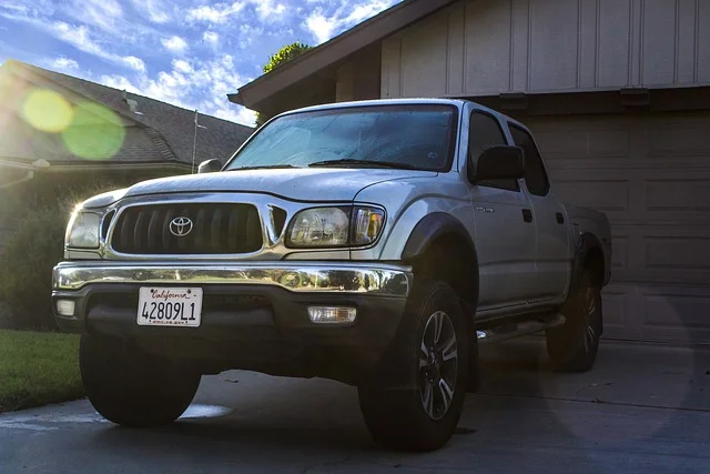 Toyota Tacoma parked in a driveway with a lens flare