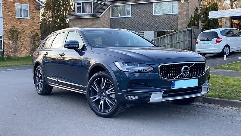 Volvo S90 parked on a street at dusk